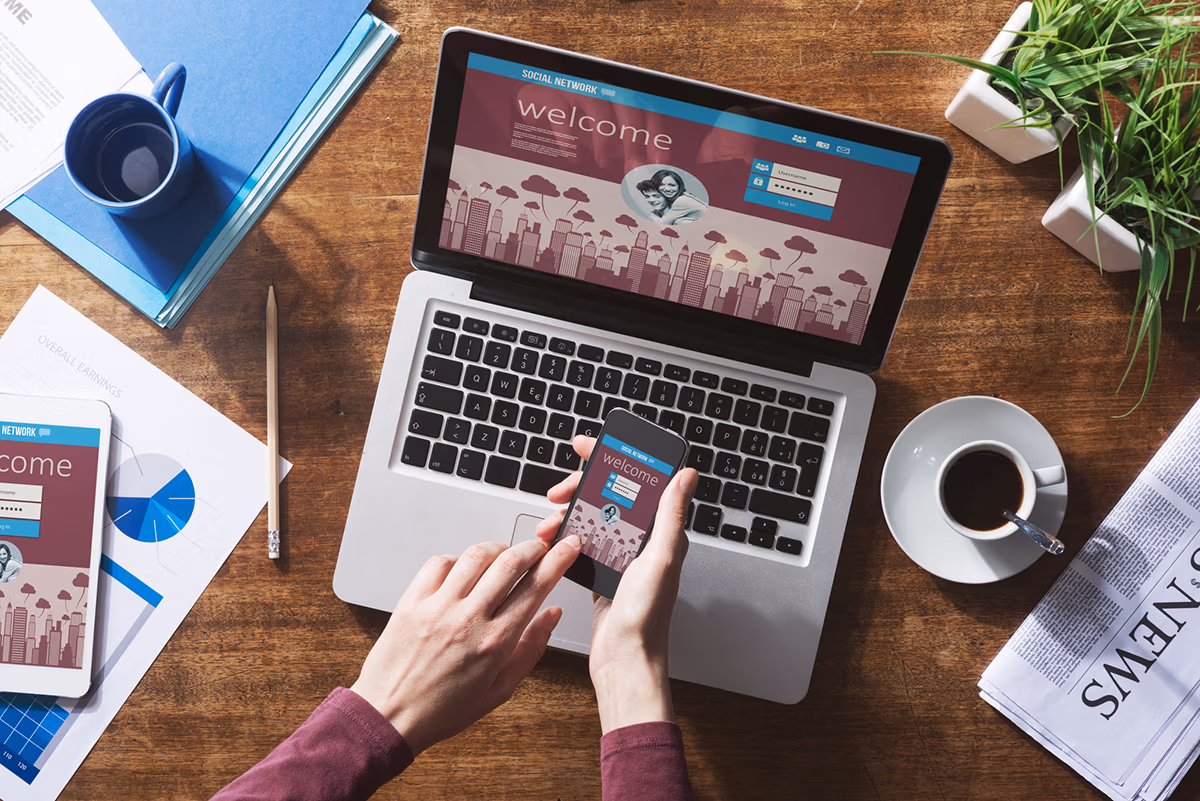 Harness the power of digital marketing: an image showing a person viewing a website on a laptop and smartphone
