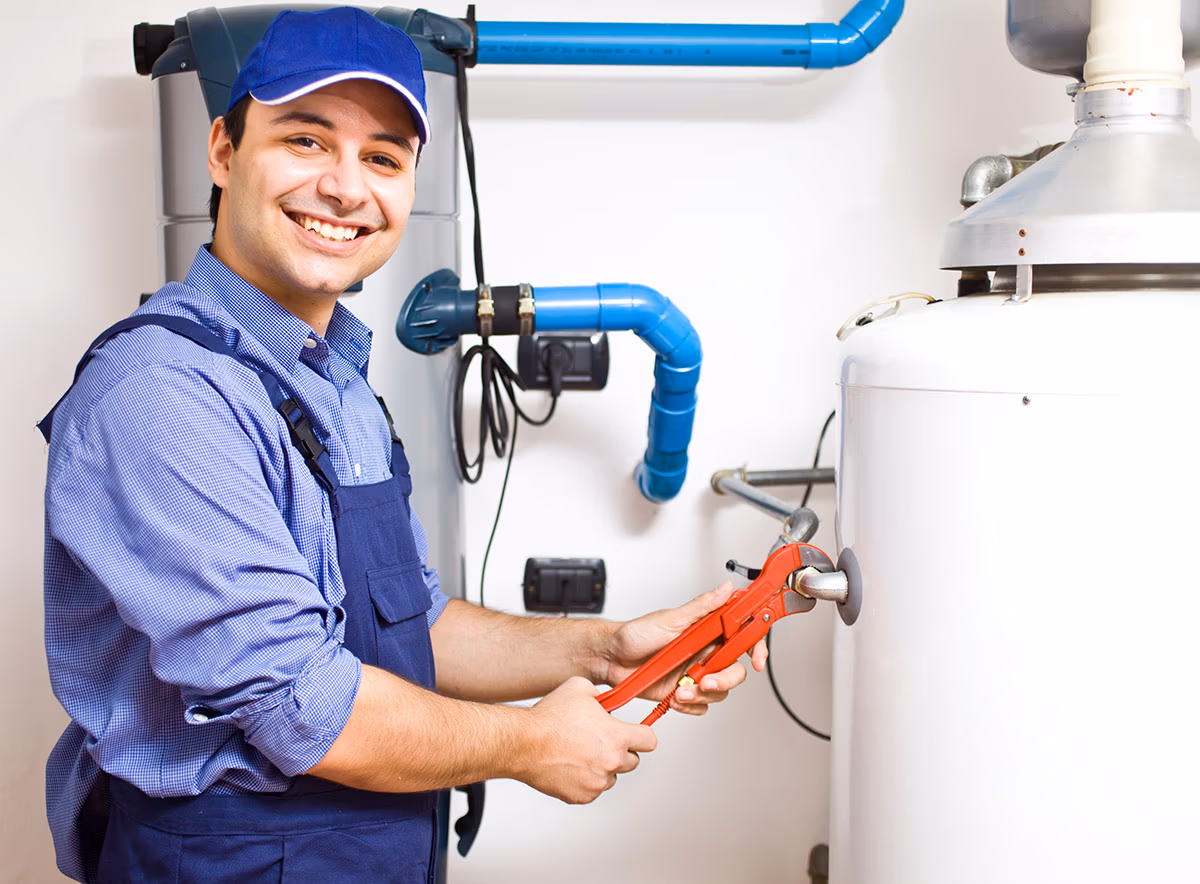 How to use video marketing: a smiling plumber facing the camera while fixing a hot water tank