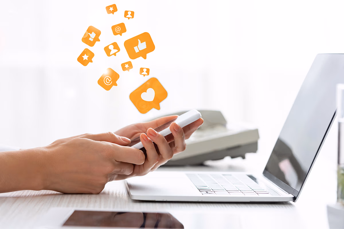 benefits of social media marketing: an image showing a surreal representation of social media likes and comments coming from a smartphone held in a woman's hands