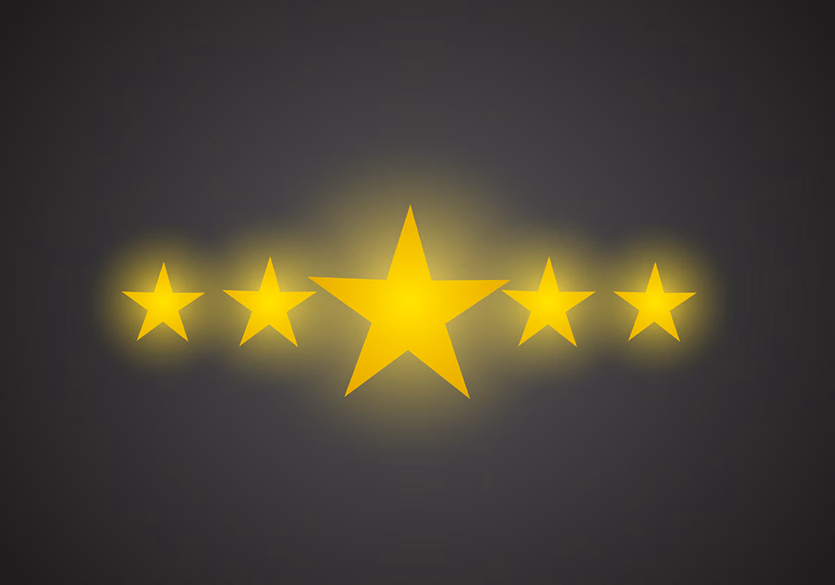 Why reviews matter: an image of five glowing golden stars on dark gray background with the center star as the biggest