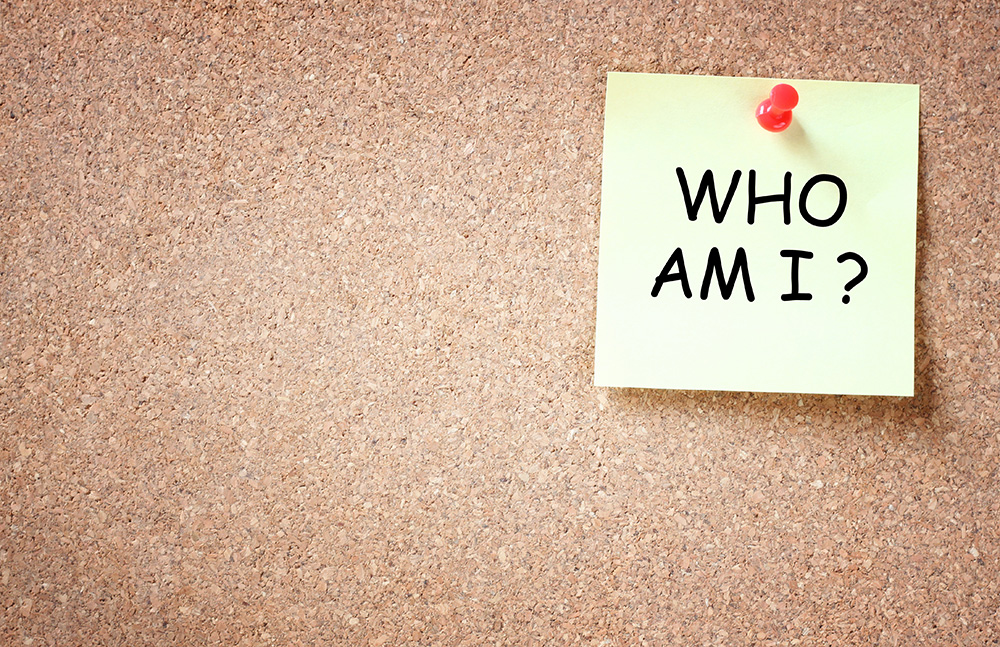 Promoting your brand: a cork board with a sticky note asking, “Who am I?”