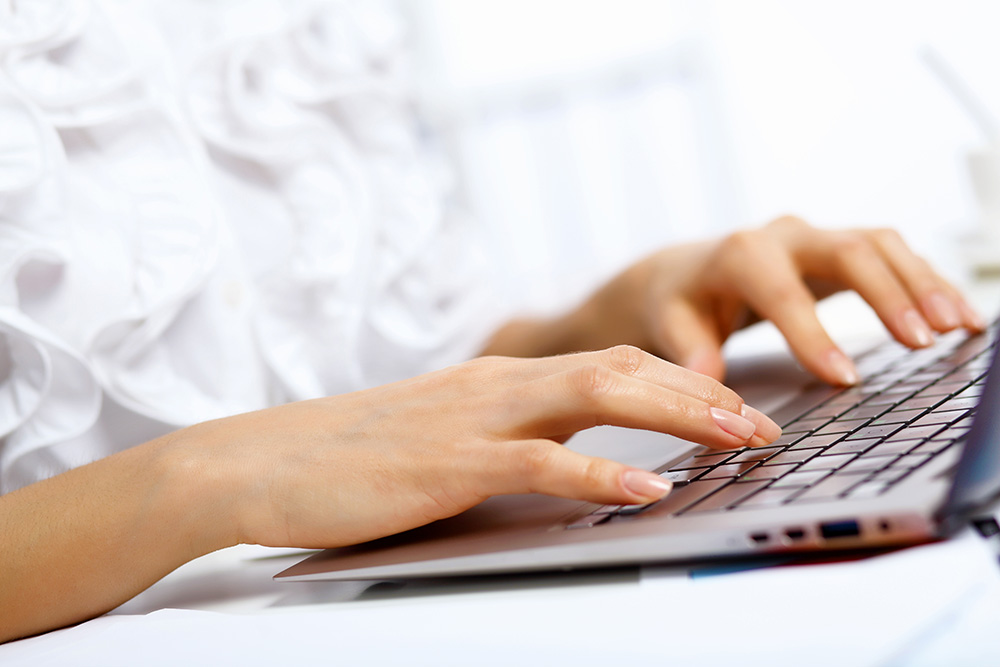 Blogging for your business: A photo showing a lady’s hands typing in a laptop