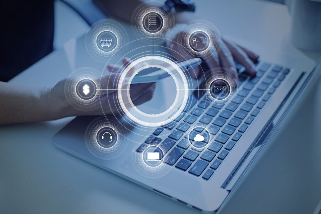 a creative representation of advertising target: a person holding a smart phone in front of a laptop.