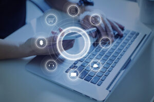 a creative representation of advertising target: a person holding a smart phone in front of a laptop.