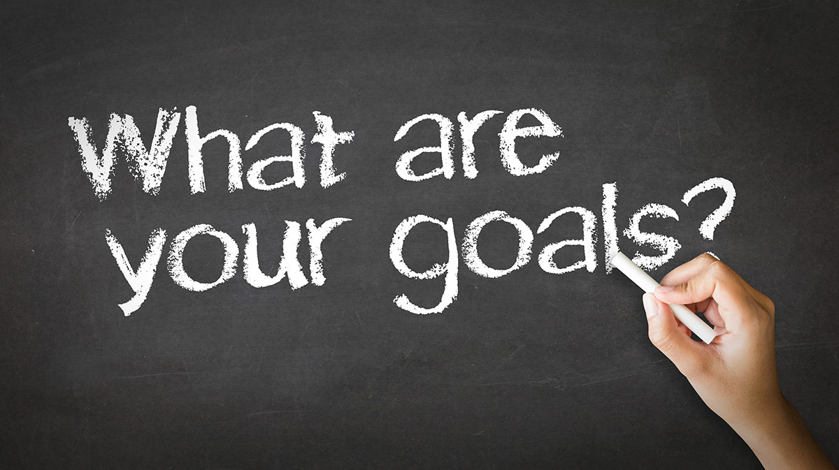 Guide to Self Storag Marketing solutions: the question "What are your goals?" written on a chalk board.