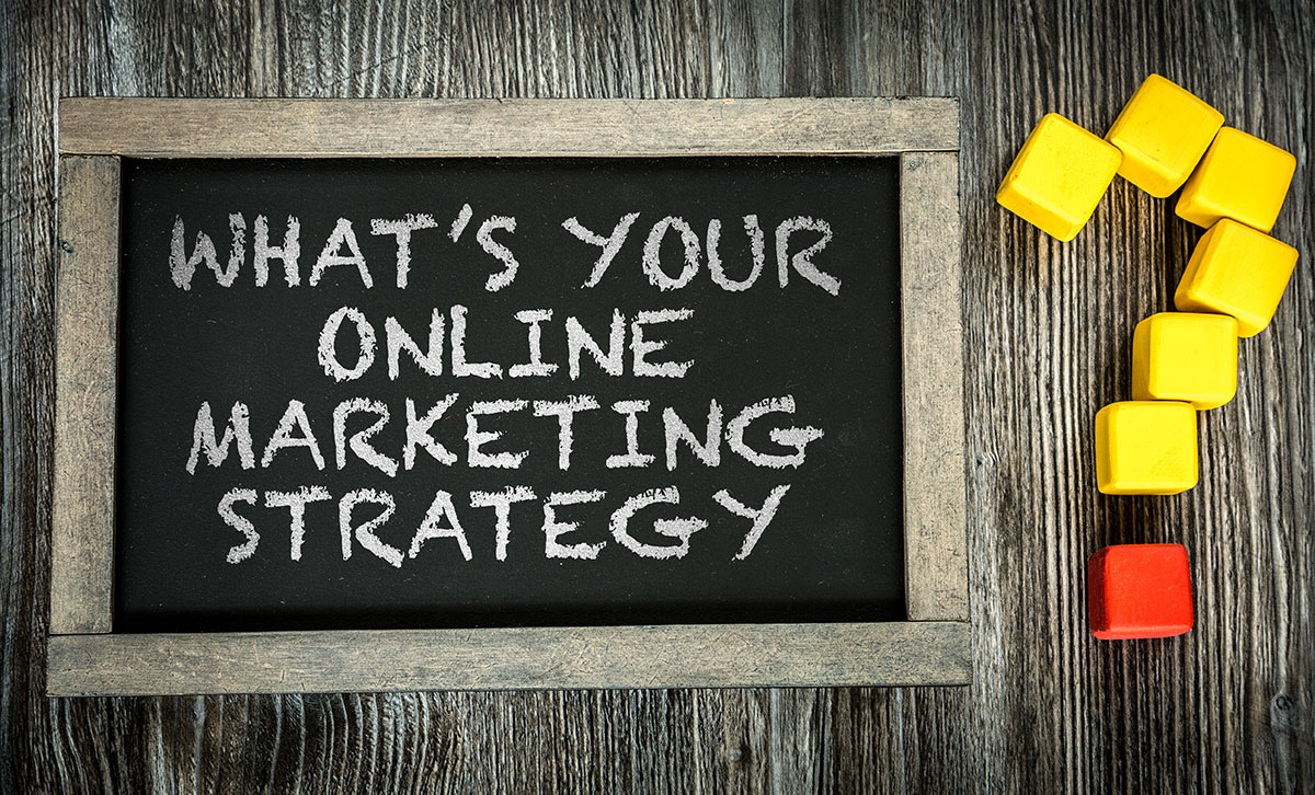 Why digital marketing matters: the question "What's your online marketing strategy" written on a chalkboard with 6 big yellow and 1 red cube forming a question mark beside it.