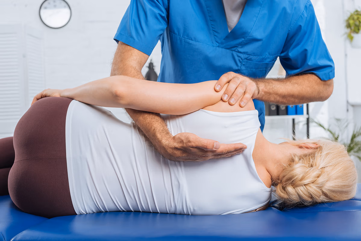 Growing your patient base with SEO for Chiropractors: an image of a chiropractor massaging a patient's back while lying on a massage table
