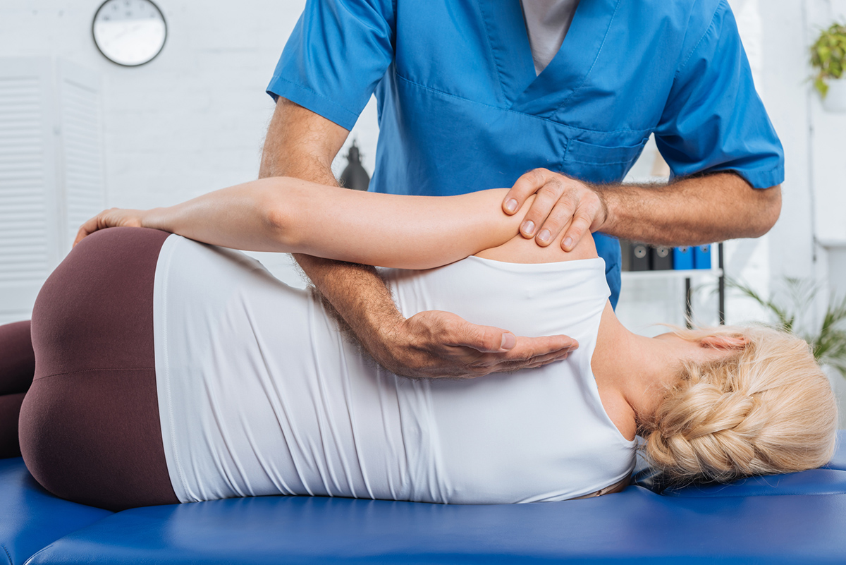 Growing your patient base with SEO for Chiropractors: an image of a chiropractor massaging a patient's back while lying on a massage table